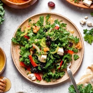Kale salad thoroughly mixed with dressing and toppings.