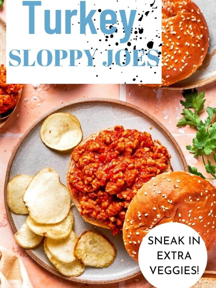 Turkey sloppy joes served with chips on a white plate.