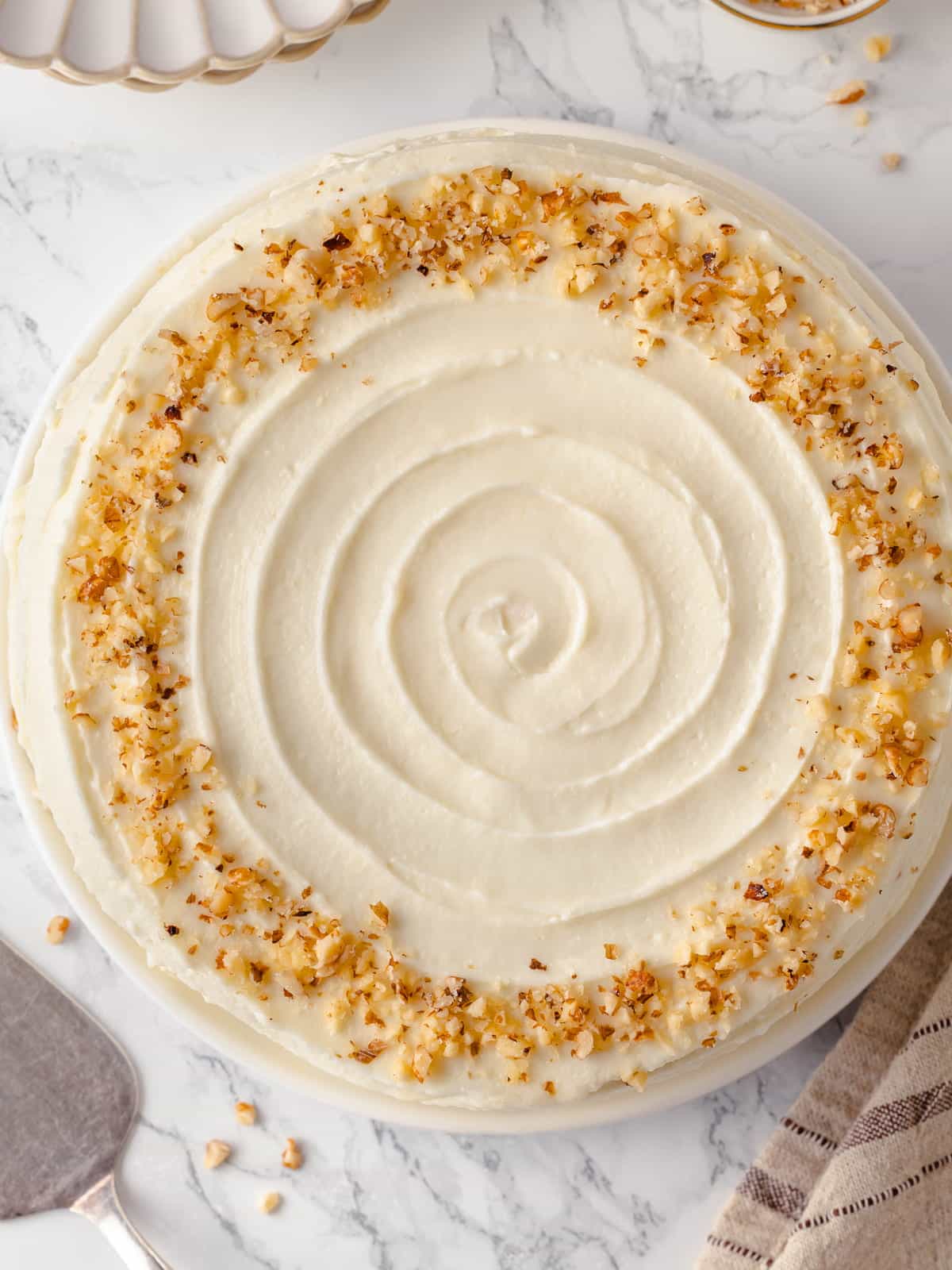 Overhead view of smooth frosted carrot cake top.