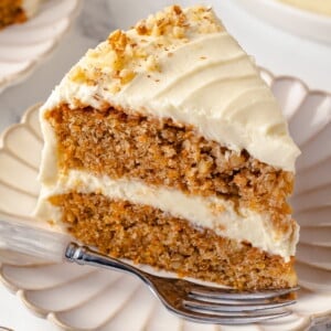 Single slice of carrot cake served on a white plate.