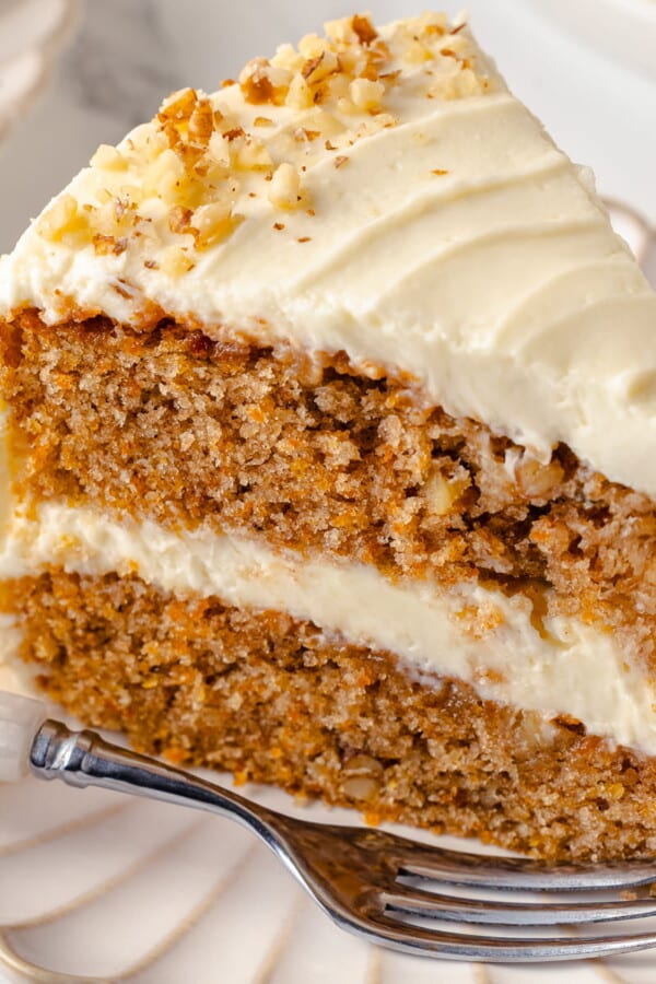Single slice of carrot cake served on a white plate.