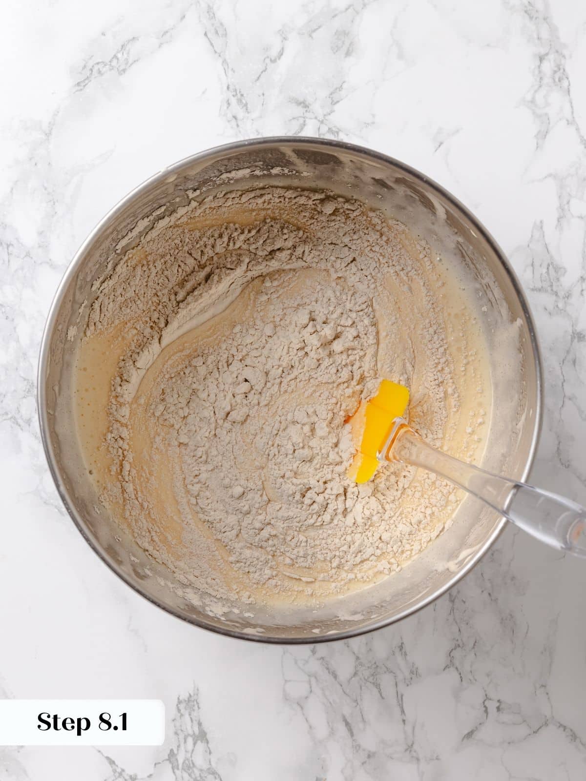 Batter showing streaks of flour before mixing is complete.