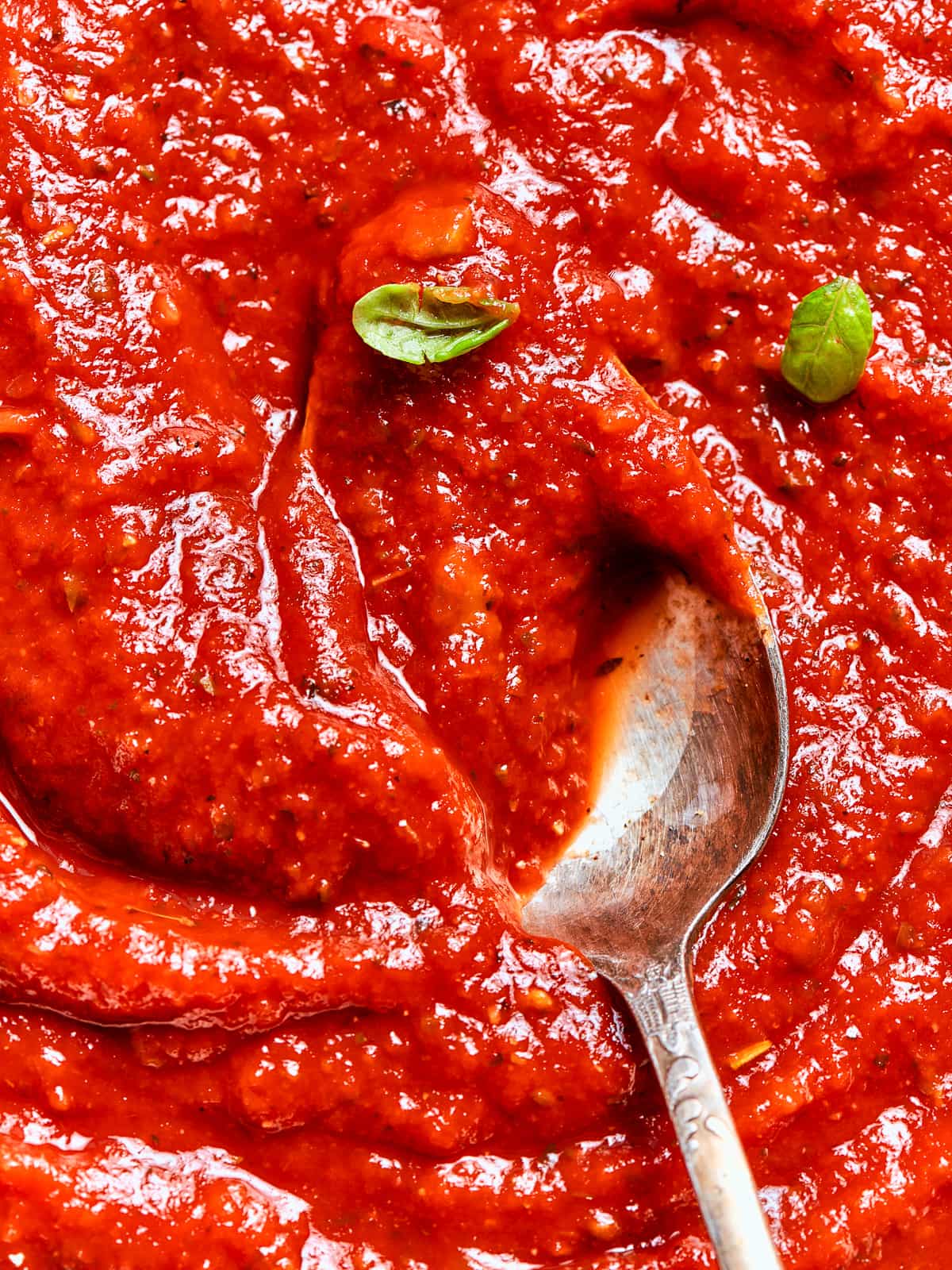 Vivid red homemade pizza sauce with a glossy finish.