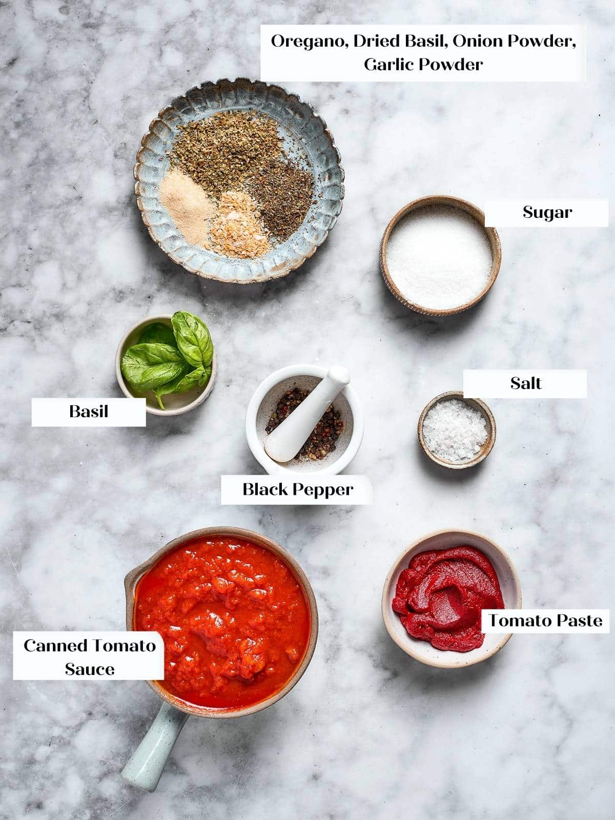 Dried herbs and tomato products prepped for homemade pizza sauce.