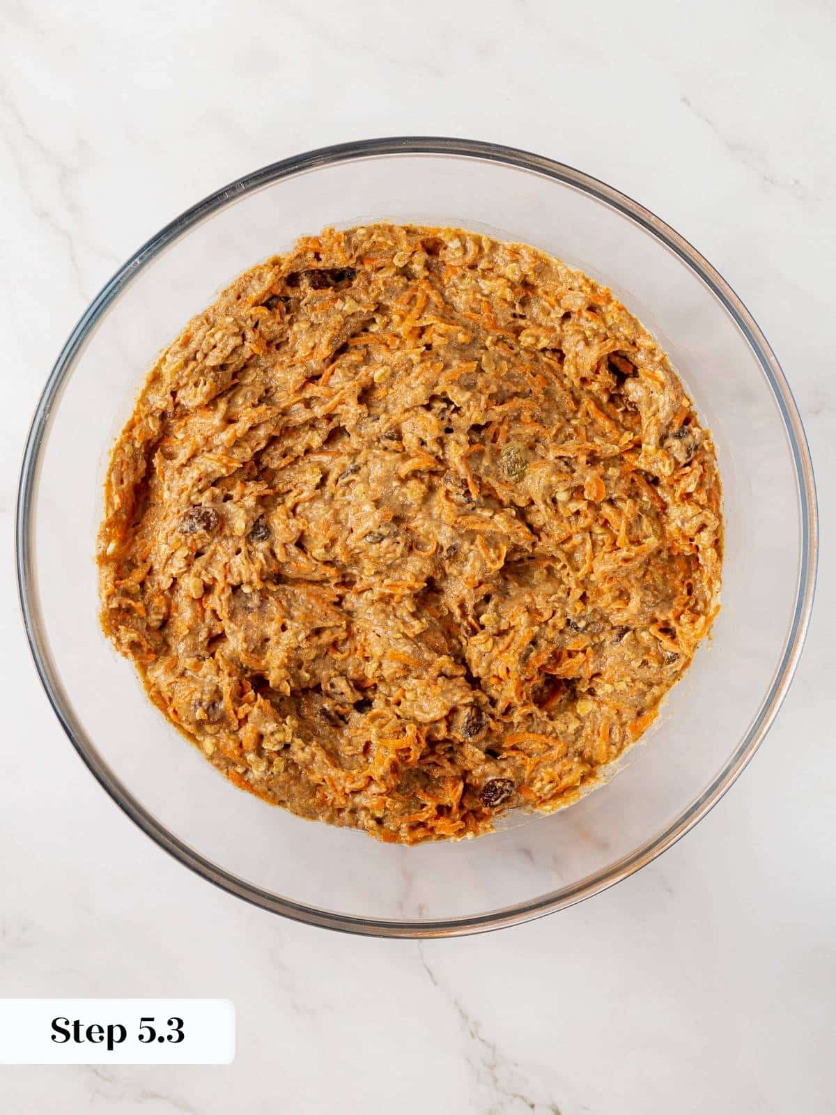 Final carrot muffin batter with grated carrots mixed in.