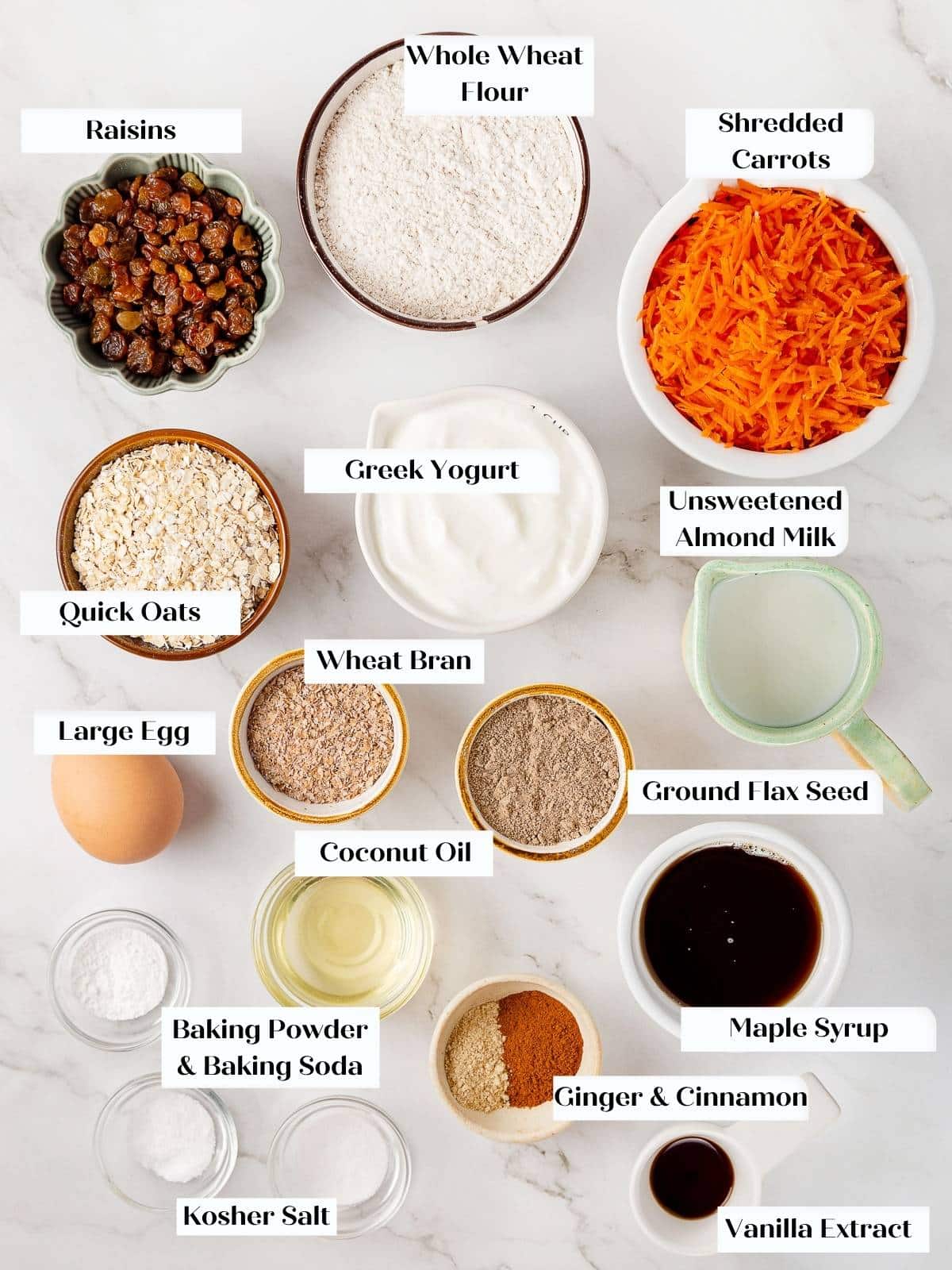 Ingredients for carrot muffins arranged on a kitchen counter.