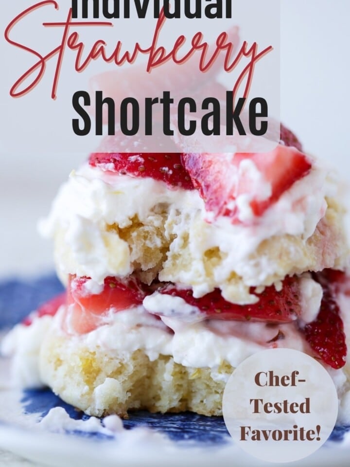 Personal-sized shortcake with golden top and whipped cream.