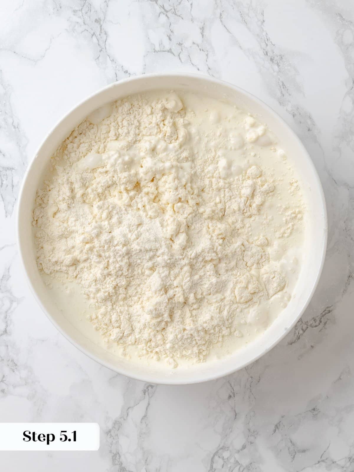 Starting to bring the shortcake dough together with cream.