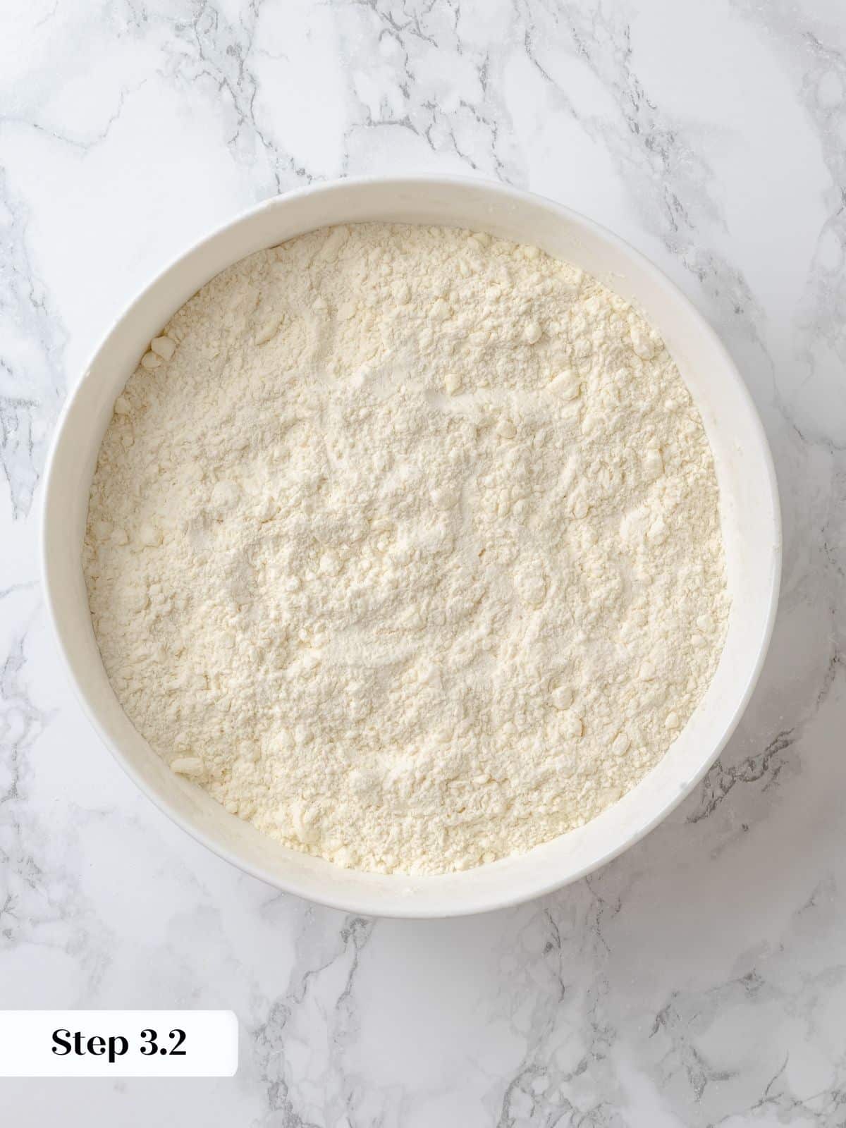 Butter cut into the flour mixture, resembling small peas.