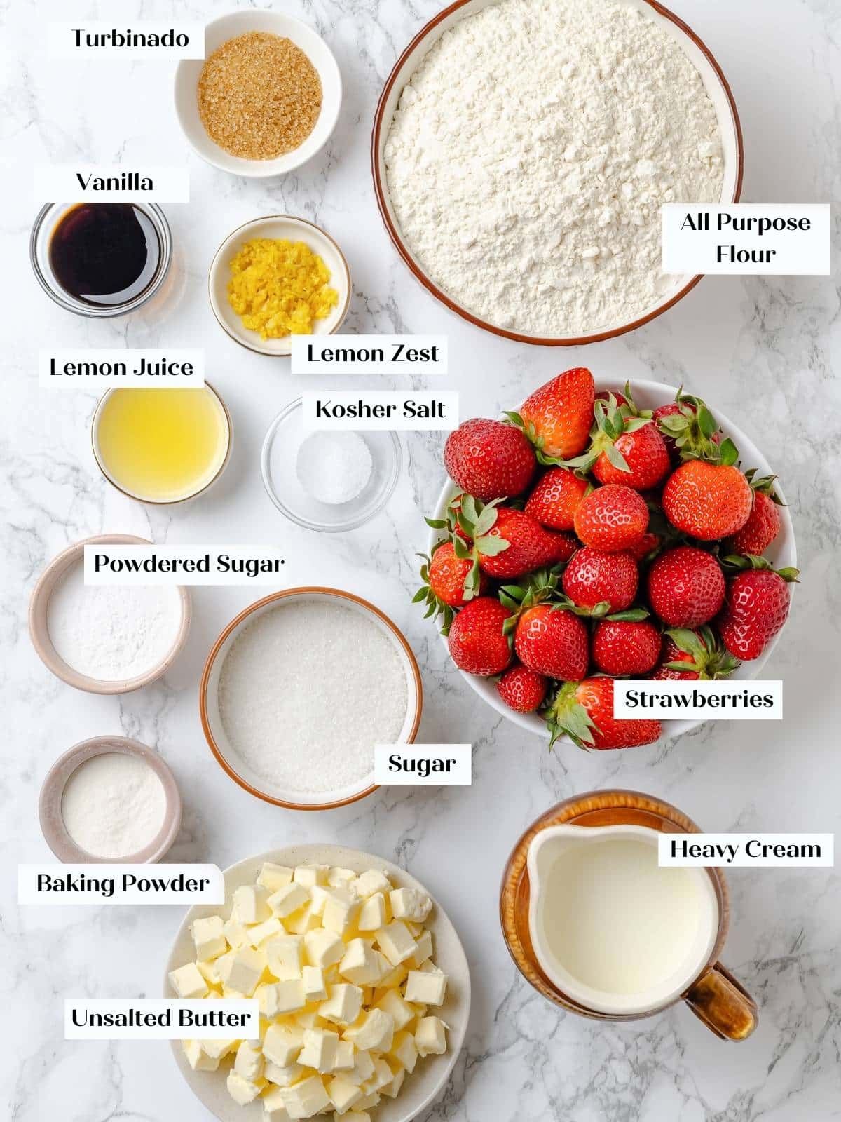 Measured ingredients for strawberry shortcakes arranged neatly on a kitchen counter.