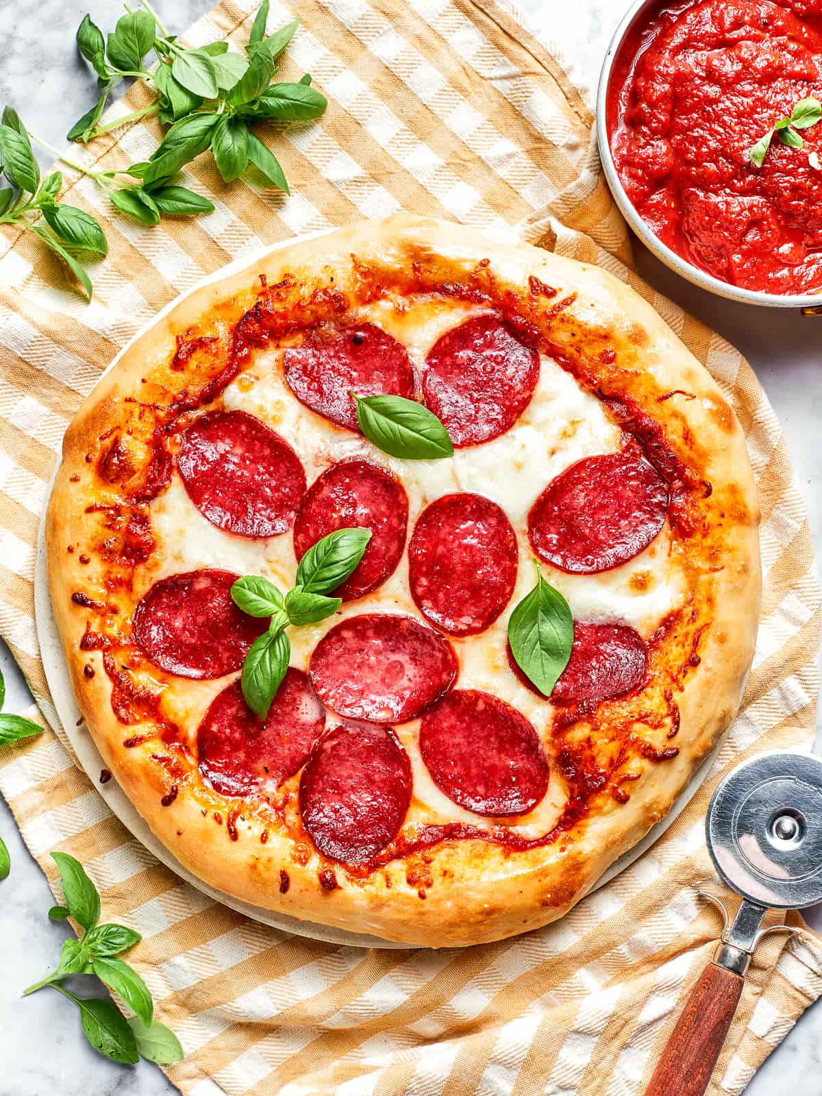Overhead view of a complete pizza with golden crust and bubbling cheese.