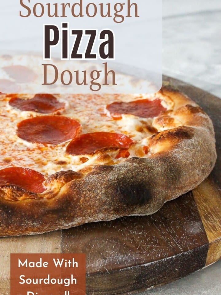 Fresh pizza crust with blistered bubbles and crispy edges.