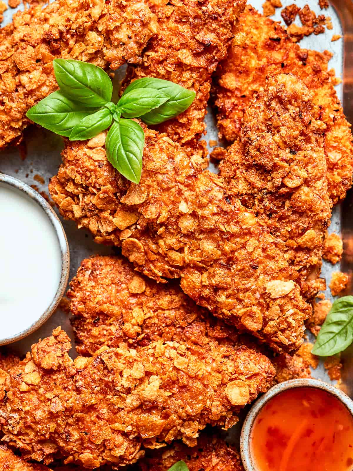 Ultra-crispy chicken tenders showing golden crust from chex and breadcrumb coating.