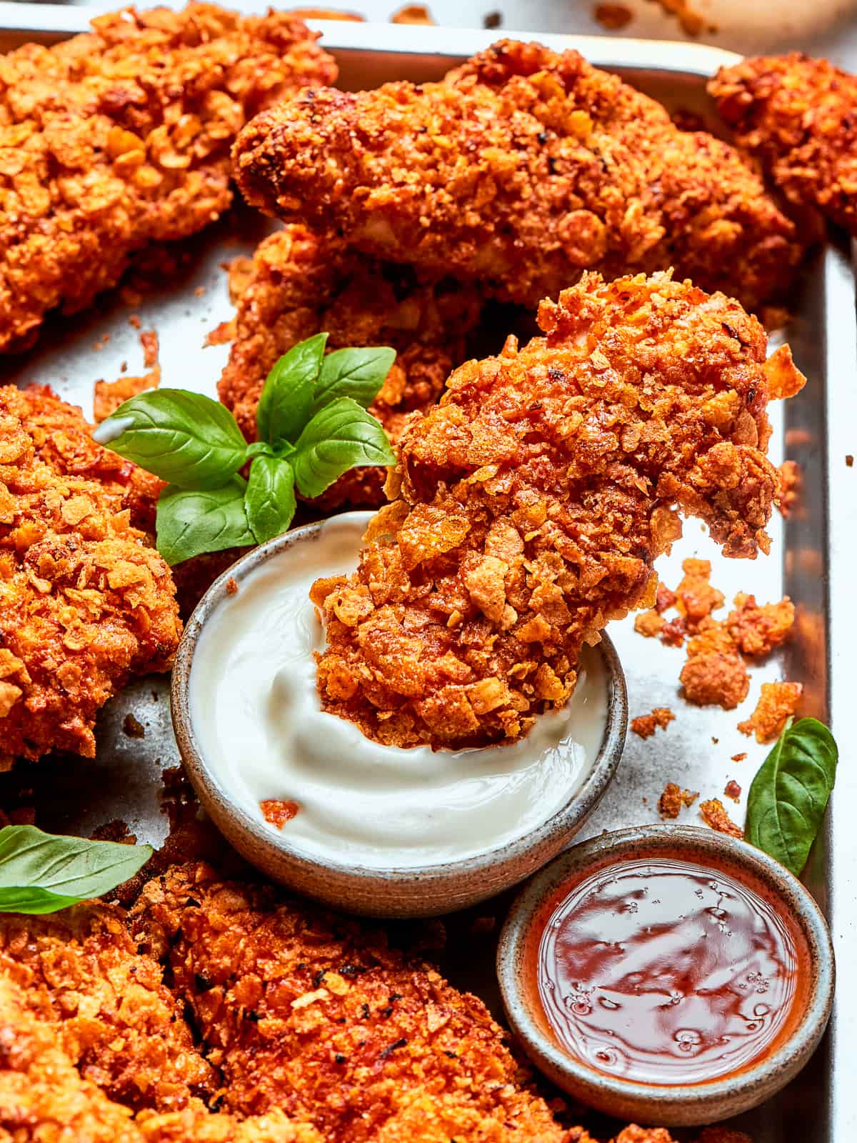 Fully cooked air fryer tenders on tray, each with uniform crisp and rich color.