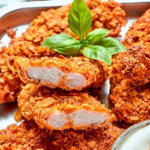 Tender interior of chicken strip surrounded by thick, crunchy breading.