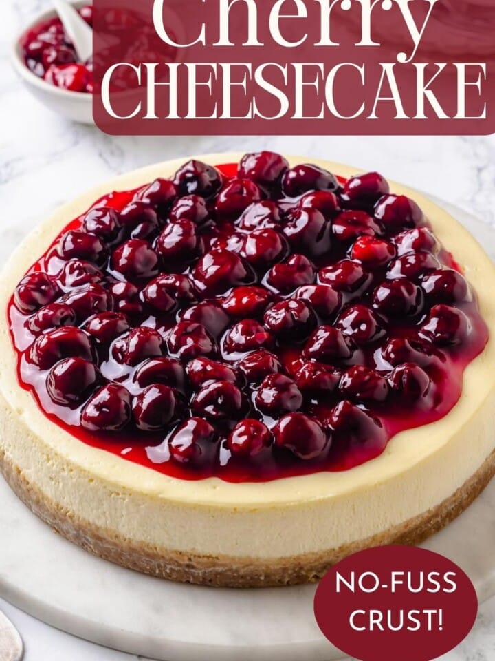 A full cherry cheesecake topped with glossy cherries for serving at a summer party.