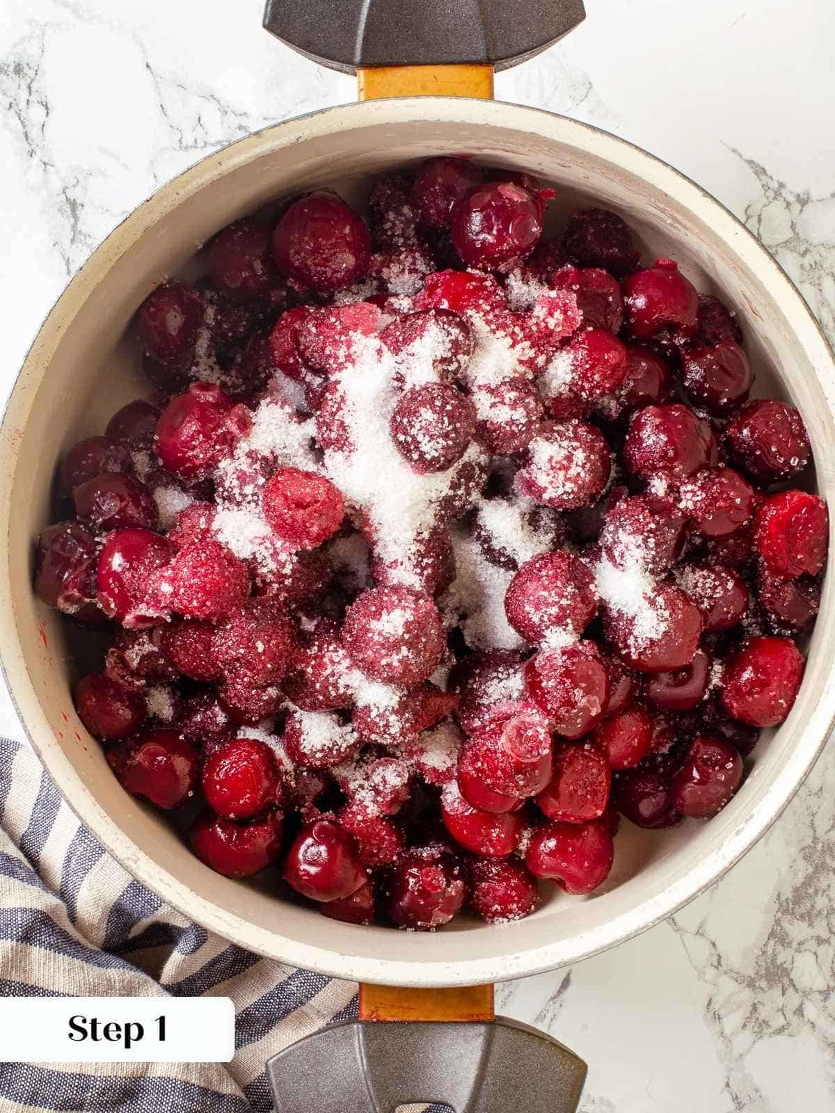 Cherries, sugar, and extract combined in a saucepan before thickening for pie filling.