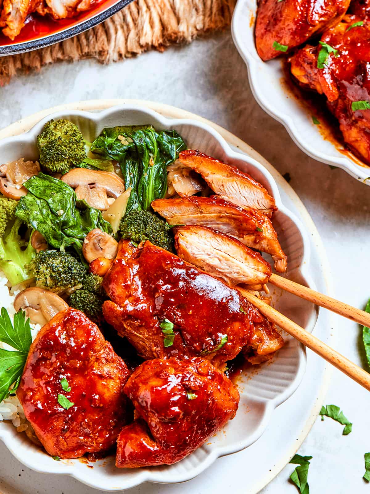 Bright green broccoli florets mingling with sauced chicken and mushrooms in stir-fry serving.
