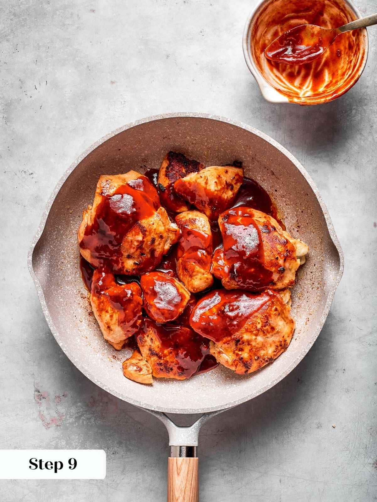 Chicken coated with freshly stirred sauce, ready to simmer into sticky perfection.