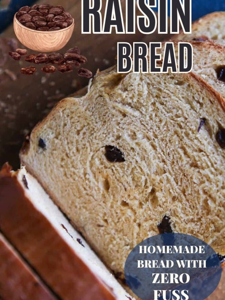 Homemade raisin bread sliced open to show the soft, chewy interior studded with juicy raisins.