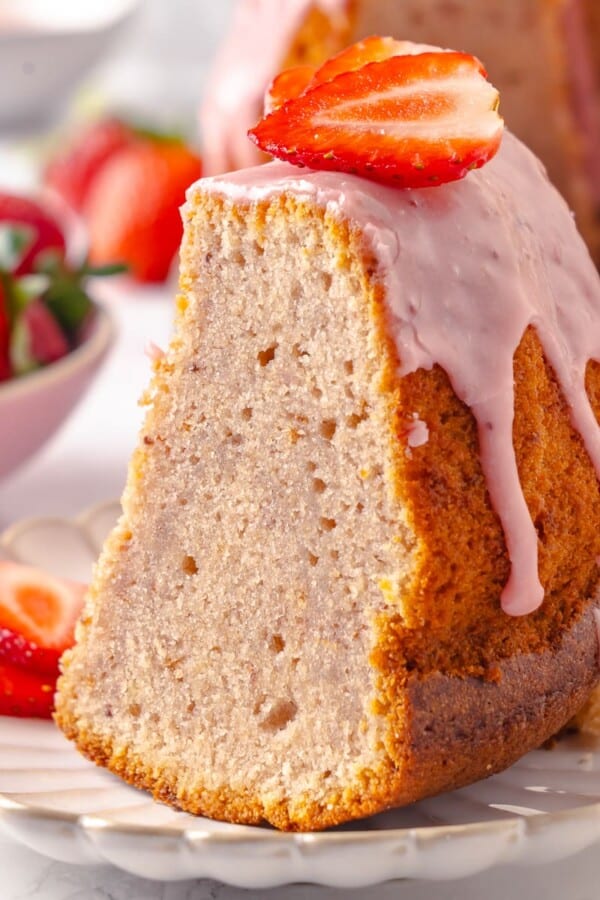 Fresh glaze dripping slowly along the cake’s edges, adding texture and color.