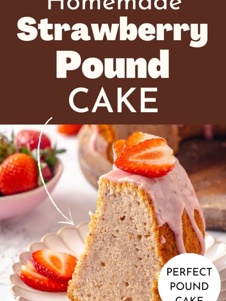 Finished strawberry pound cake with strawberries arranged on top and a thick pink glaze shining brightly.