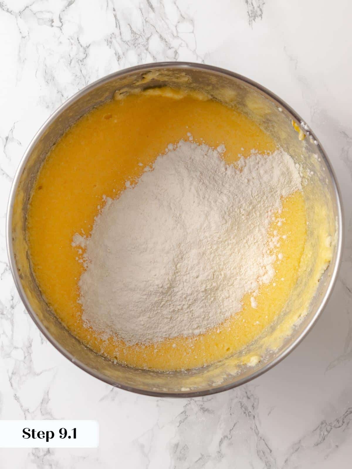 Dry ingredients added gradually to the wet mixture in a large mixing bowl.