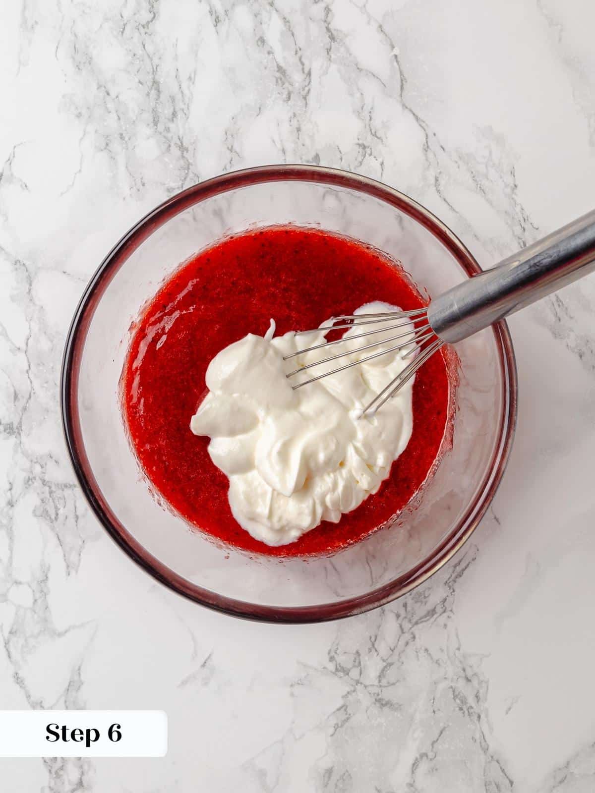 Sour cream added to strawberry jam to create a tangy, creamy component.