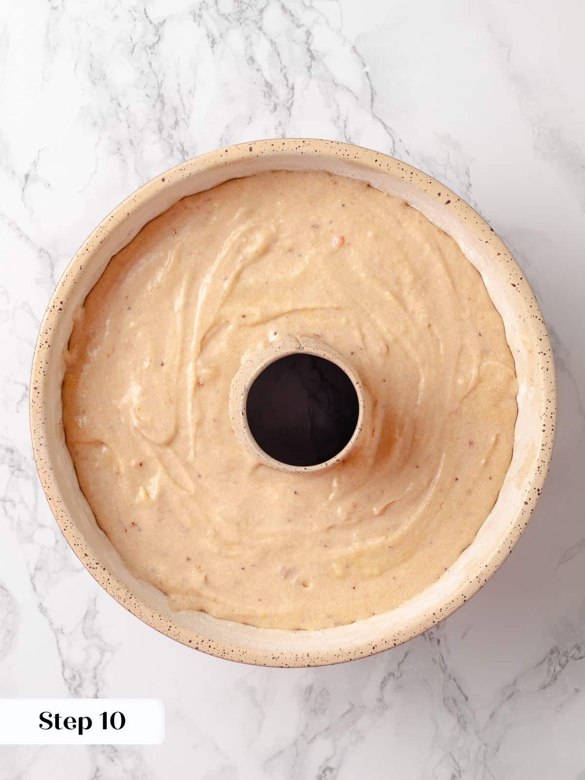 Cake batter smoothed into a bundt pan, ready for baking.