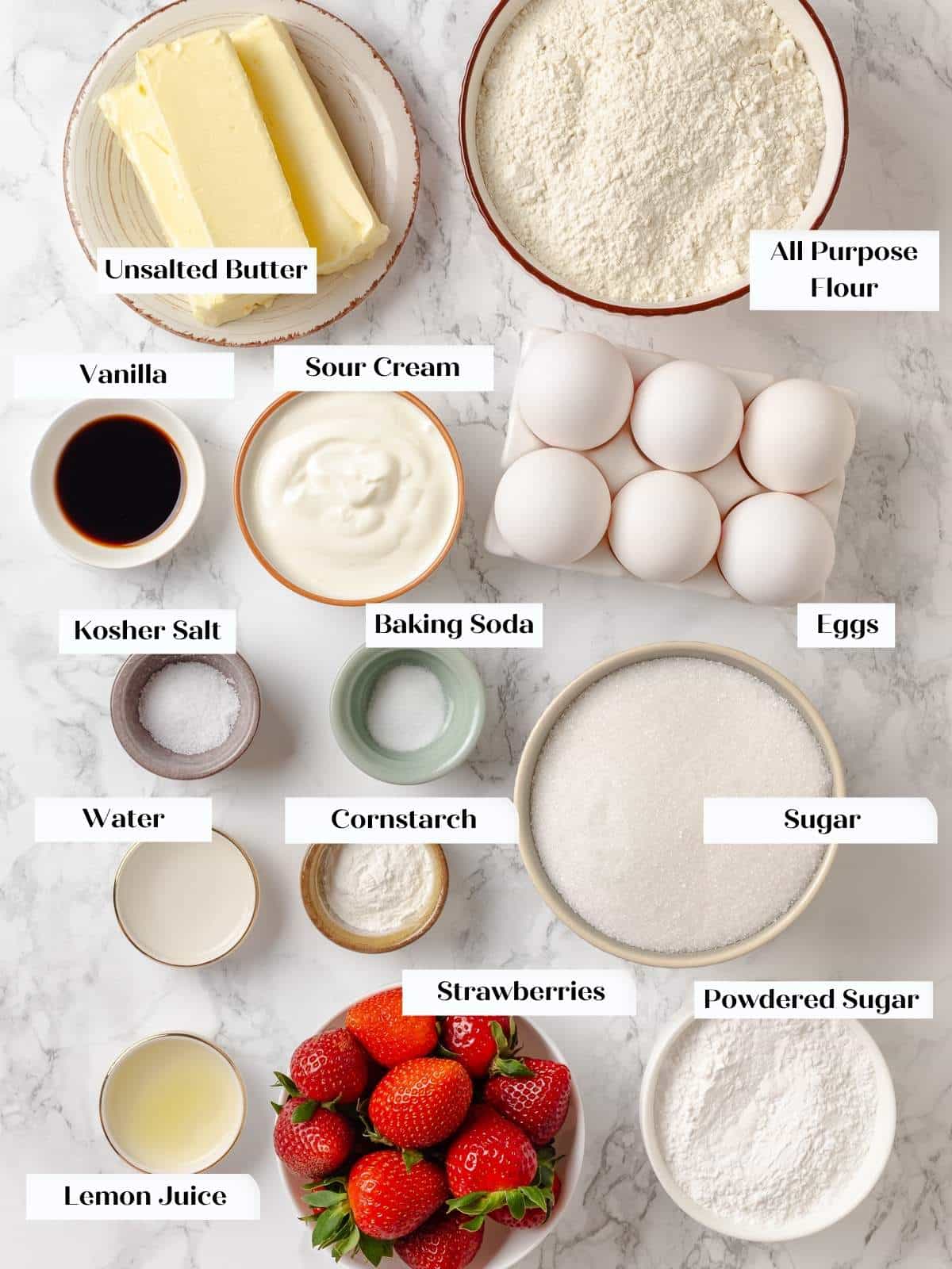 All ingredients for strawberry pound cake measured and arranged on a kitchen counter.