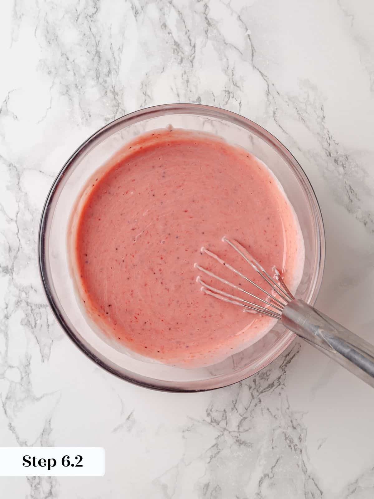 Sour cream blended with strawberry jam, creating a creamy pink mixture for the batter.