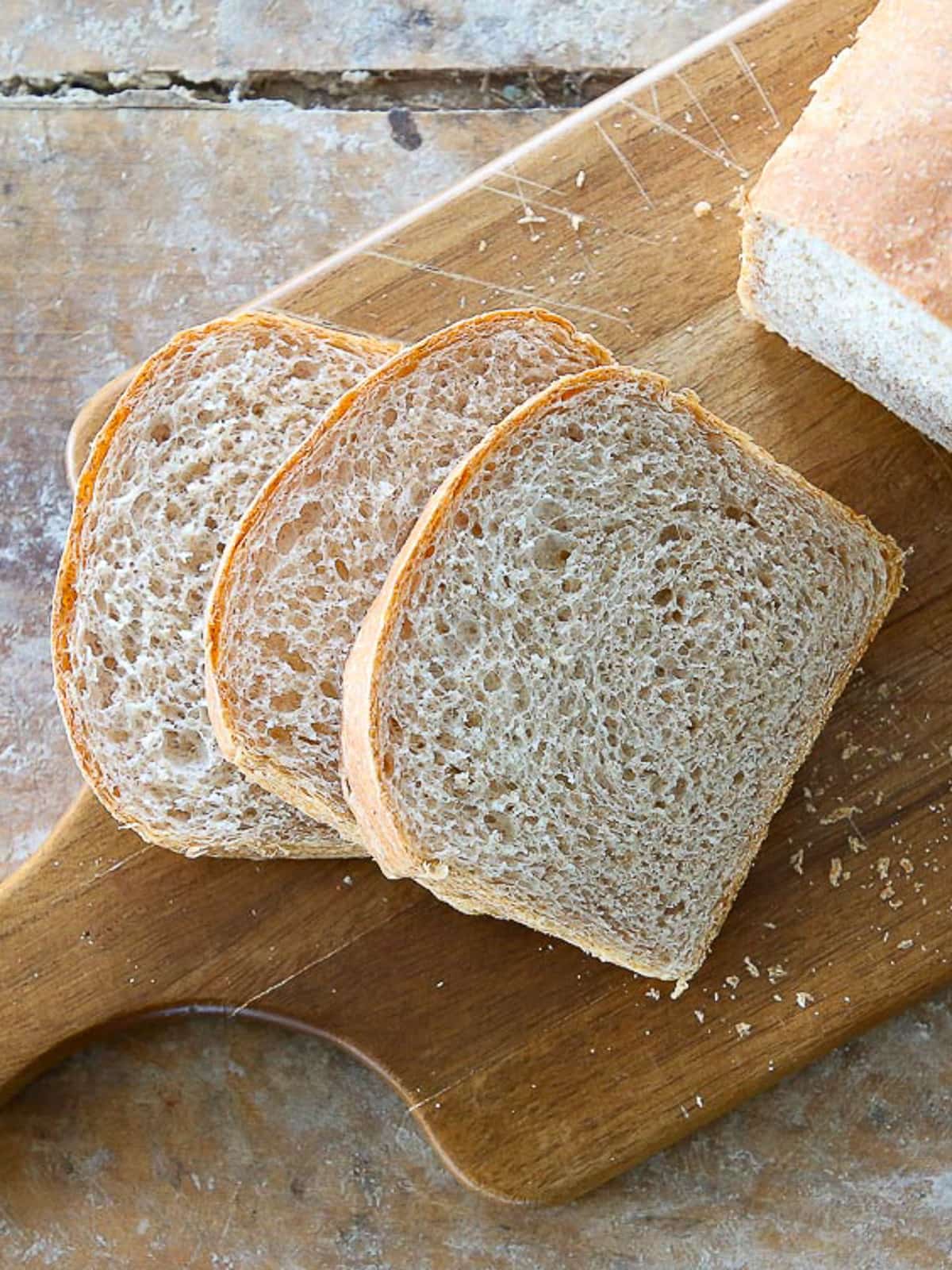 A soft sandwich loaf with even slices revealing a tender crumb and golden crust.