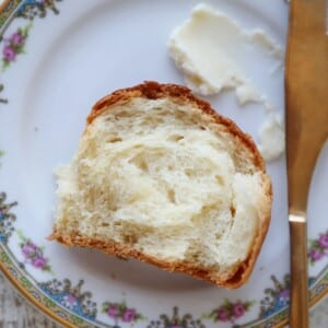 Interior of a dinner roll showcasing the fluffy, pillowy texture of the crumb.