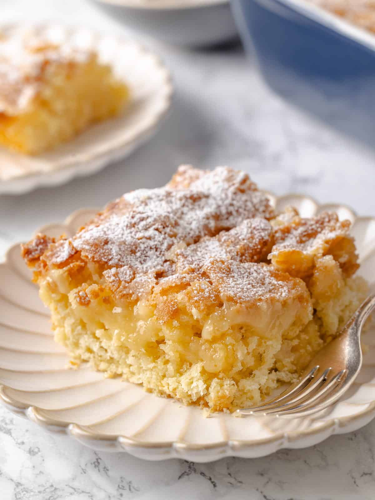 A visibly gooey middle sits beneath the crusty top of this traditional butter cake.