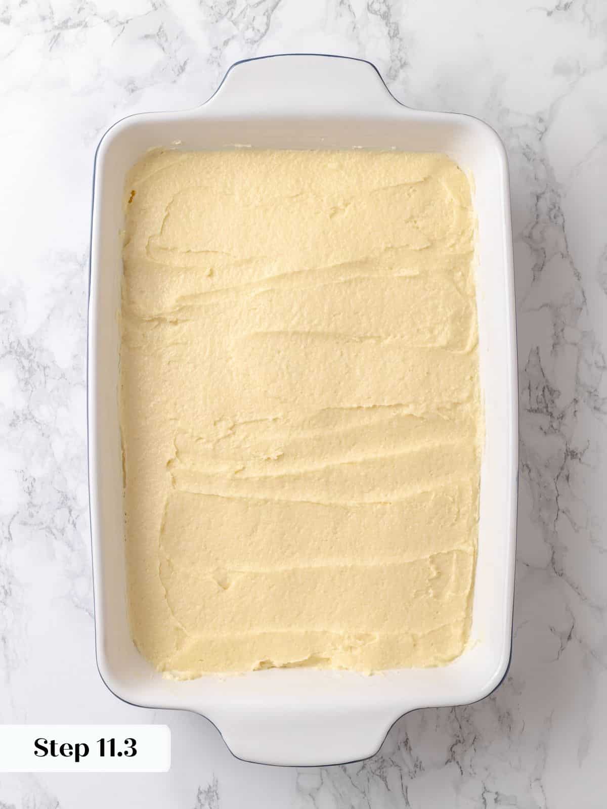 Soft batter spread to edges of the dish before rising and adding the topping.