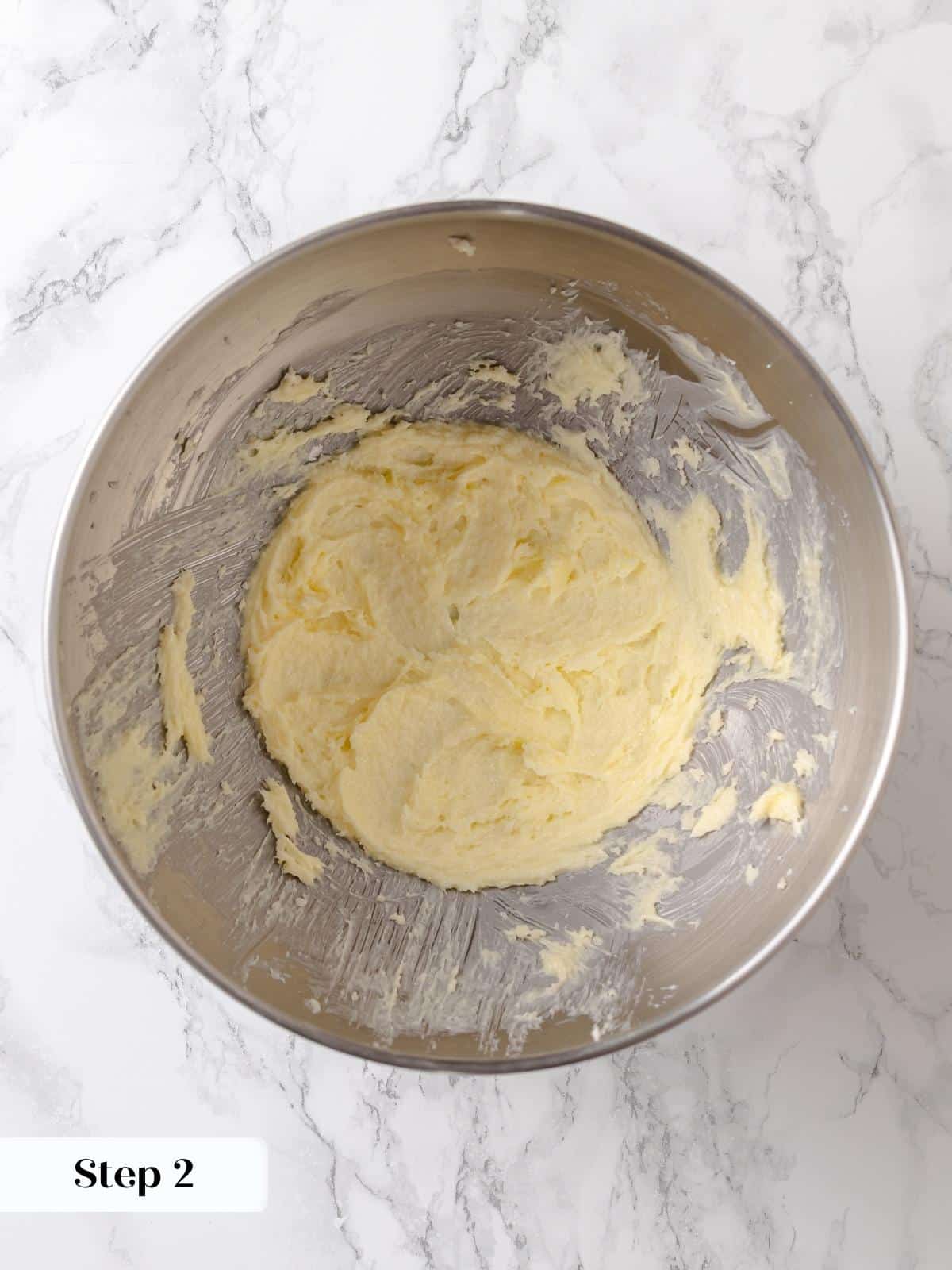 Butter and sugar mixture is creamed until lightened, forming the first step of the cake.