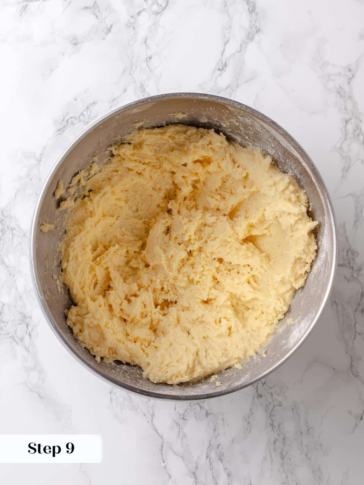 Flour and salt are incorporated into the butter and sugar mixture for the cake base.