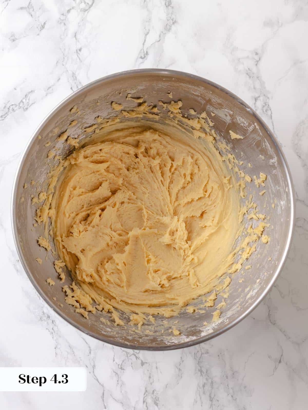 Smoothed dough in pan forms a soft base before rising and topping are added.