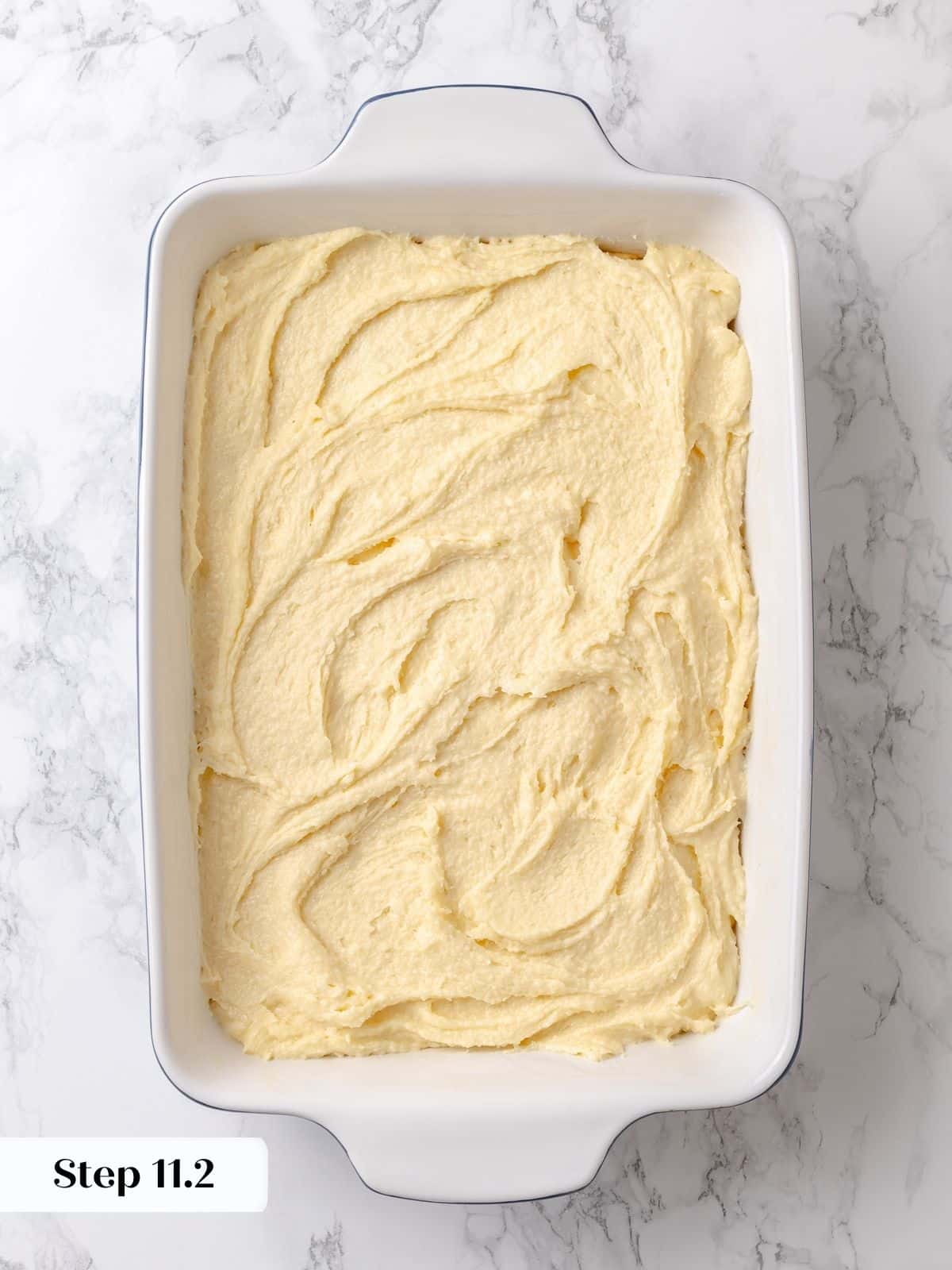 Gooey topping layer fully covers the base, ready to bake into signature texture.