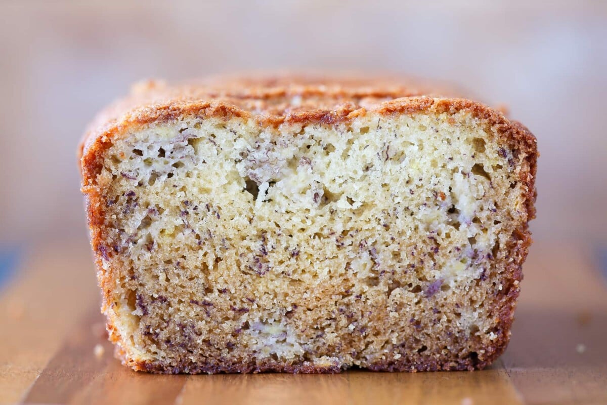 Inside texture of banana bread shown with visible soft crumb and golden outer crust.