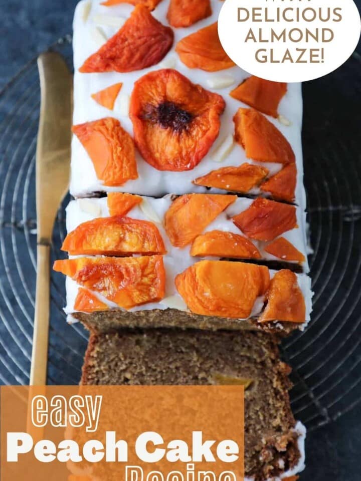 Sliced loaf cake from above, showing the white almond glazed topping and pretty slices of dried peach on top.
