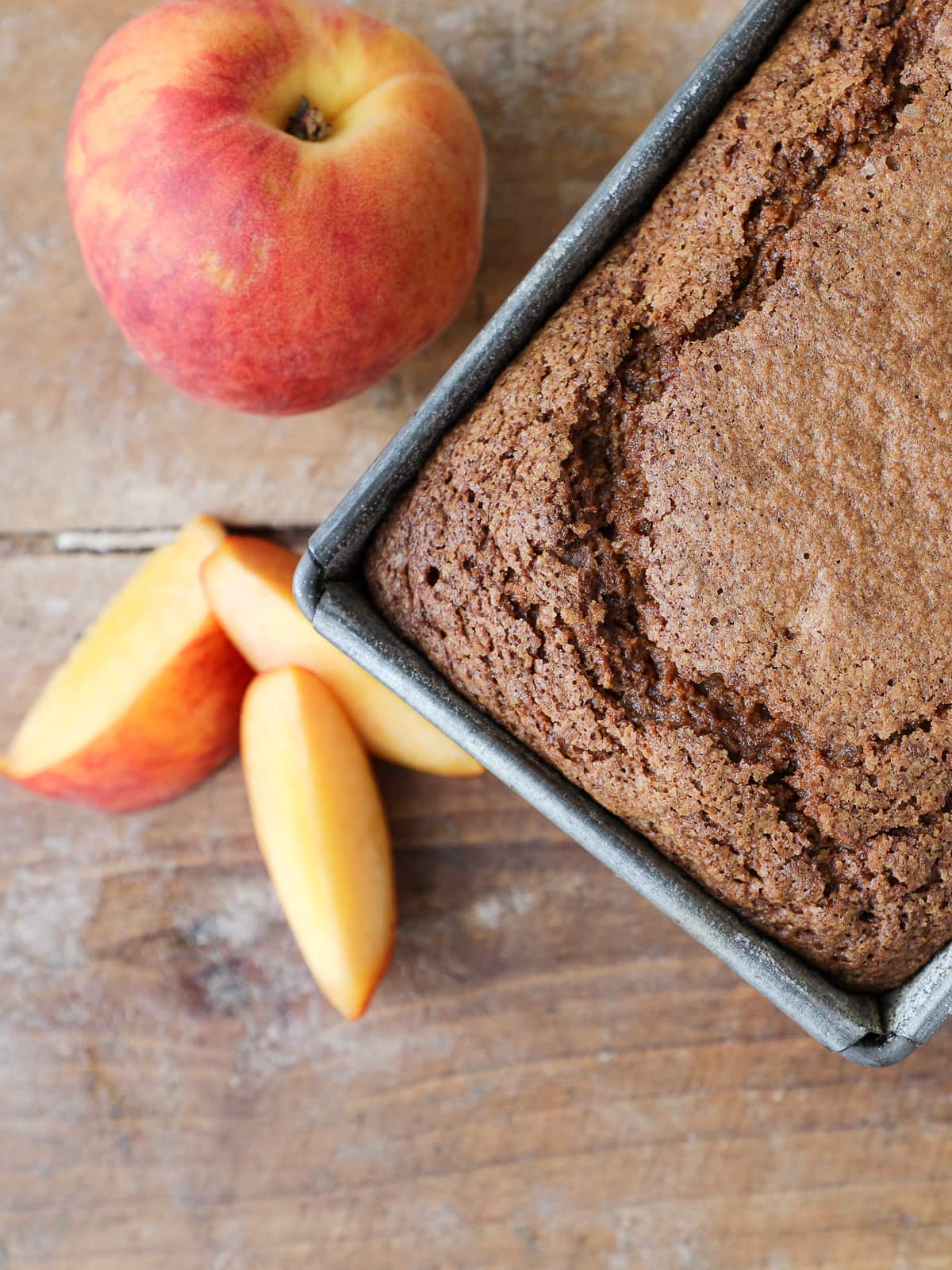 Fresh peach loaf cake without glaze, cooling in the pan after baking.