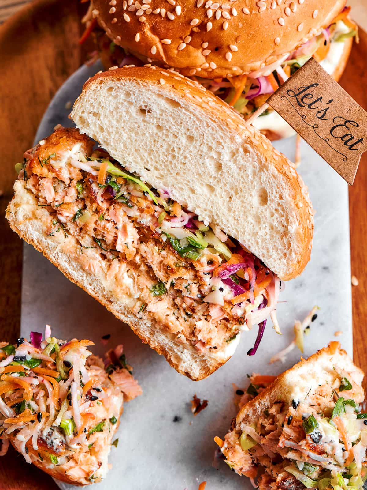 Salmon burger sliced in half to display flaked texture and visible herbs.