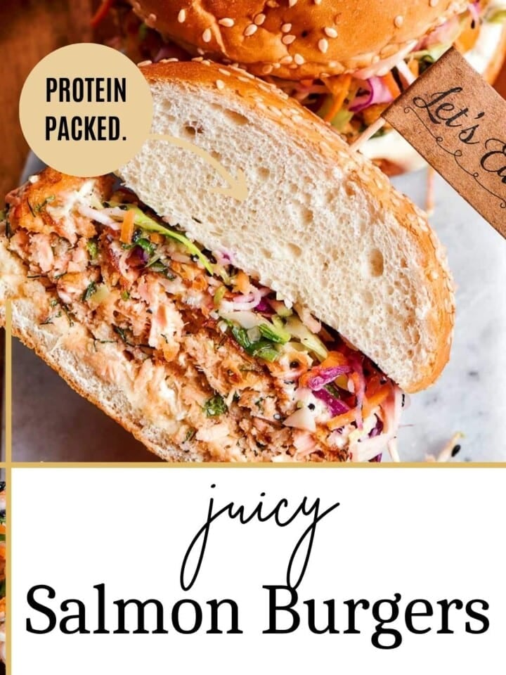 Fully assembled salmon burger with golden crust, fresh toppings, and tzatziki melting into the bun.