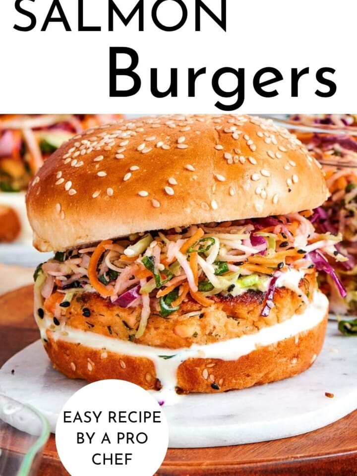 Salmon burger layered on a toasted bun with broccoli slaw and creamy tzatziki, ready to serve.