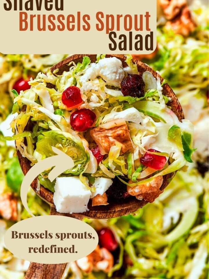 Cold salad with thinly shaved Brussels sprouts, nuts, and fruit served as a holiday dinner side.