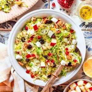 Final salad served in a bowl with vibrant pears, nuts, and tart cherries mixed throughout.