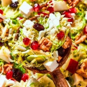A full spoonful of Brussels sprout salad showing layered textures and bright ingredients.