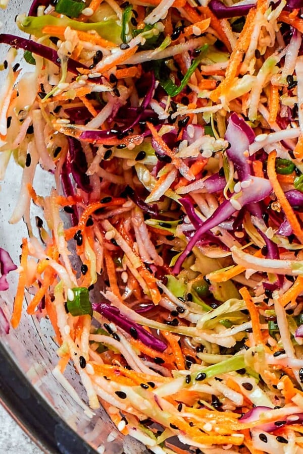 Cabbage and broccoli slaw blend shown with visible texture from shredded vegetables and toasted seeds.