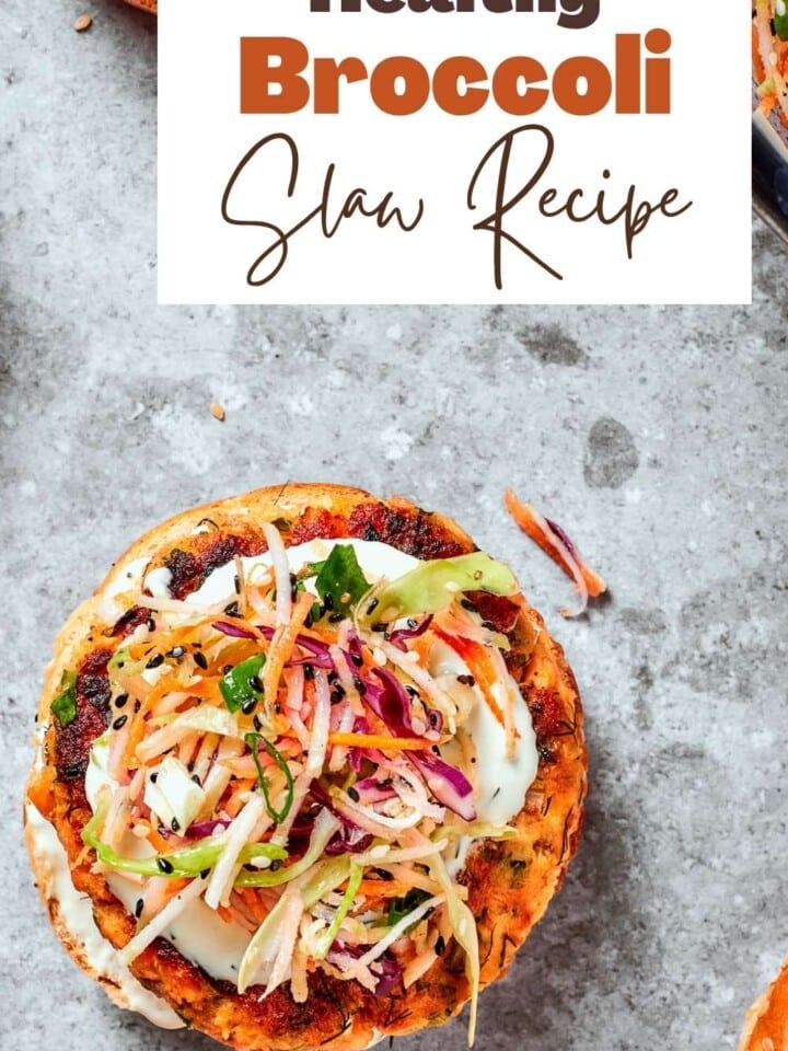 Fresh broccoli slaw with sesame seeds and red wine vinegar on a salmon burger patty.